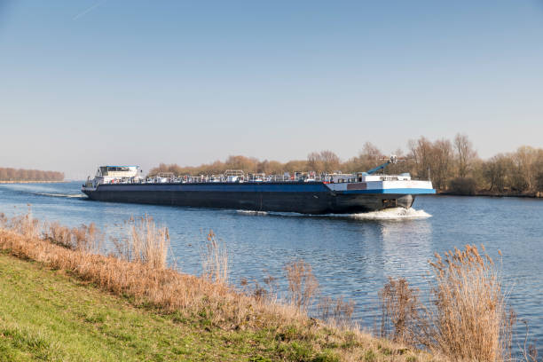 cargo ship transport in holland over the river stock photo