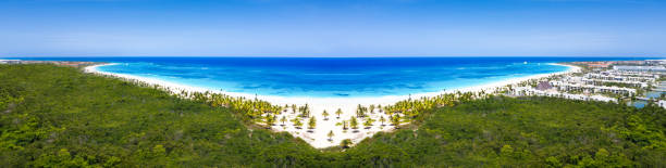 Caribbean beach of Atlantic ocean with luxury resorts, travel destination stock photo