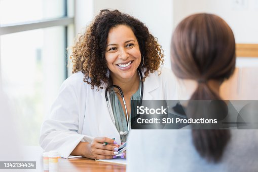 istock Caring doctor listens to patient 1342134434