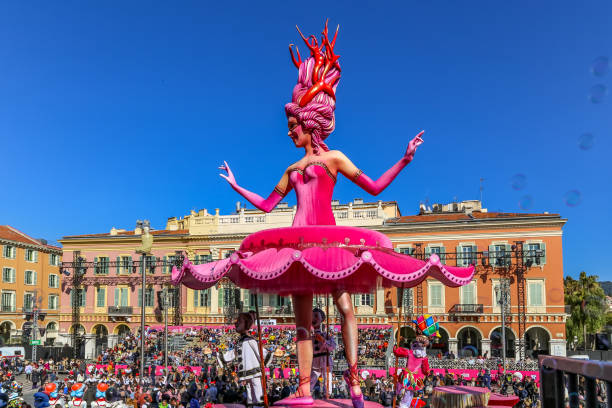 Carnaval de Nice, This years theme King of Cinema (ROI du Cinéma)  -  Bubbles floating past the hot pink coloured ballarina float with clear blue sky stock photo
