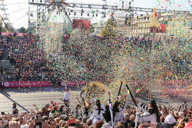 Carnaval de Nice, This years theme King of Cinema (ROI du Cinéma)  - Excitement begins as streamers and confetti are released into the stands by performers as the parade begins stock photo
