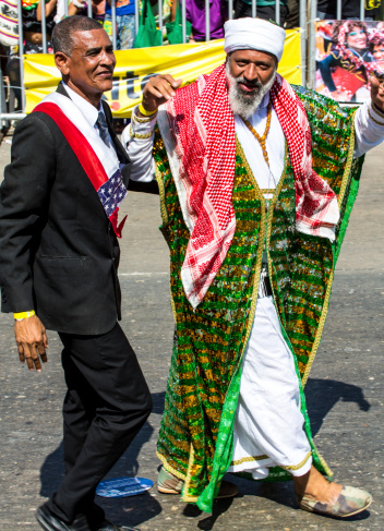 Barranquilla, Colombia - March 1, 2014: Barranquilla, Colombia - March 1, 2014 - Performers dressed as Barrack Obama and Osama bin Laden have the crowd cheering as the participate in the Battalla de Flores. The pinnacle parde of the Carnival de Barranquilla.