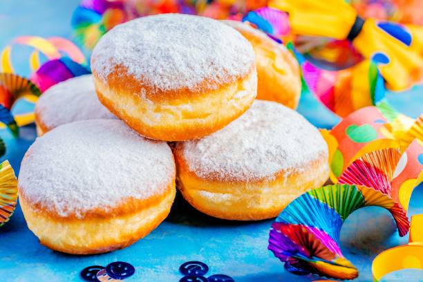 Carnival powdered sugar donuts with paper streamers stock photo