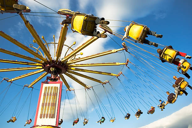 Carnival Ride - Swing Chairs Looking up as swinging chairs on chairs swirl overhead. physics photos stock pictures, royalty-free photos & images