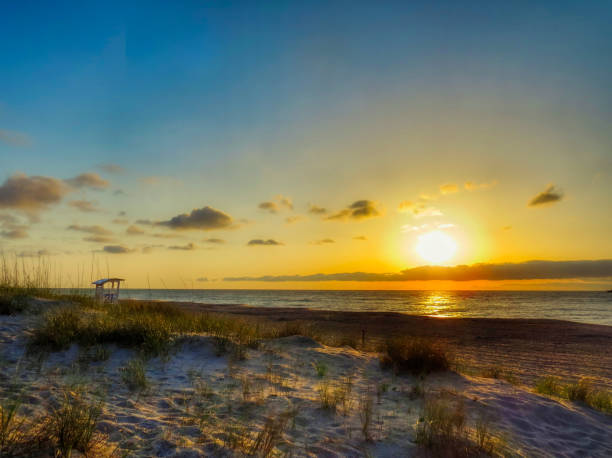 Carolina Beach Sunrise Seascape A beautiful cloudy ocean sunrise at the Carolina Beach in North Carolina. carolina beach north carolina stock pictures, royalty-free photos & images