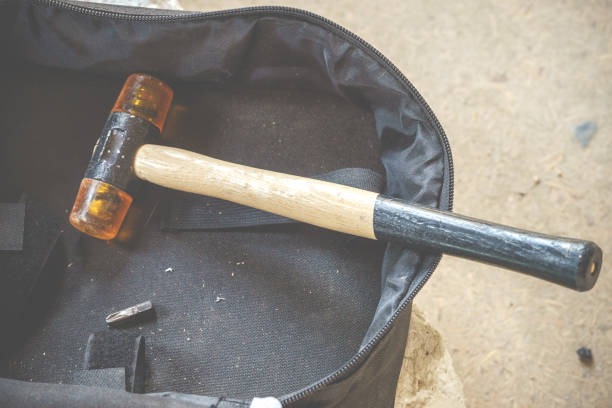 a carpentry hammer with a soft plastic finish to pat a sheet. double-face rubber hammer with wood handle - plastic hammers imagens e fotografias de stock