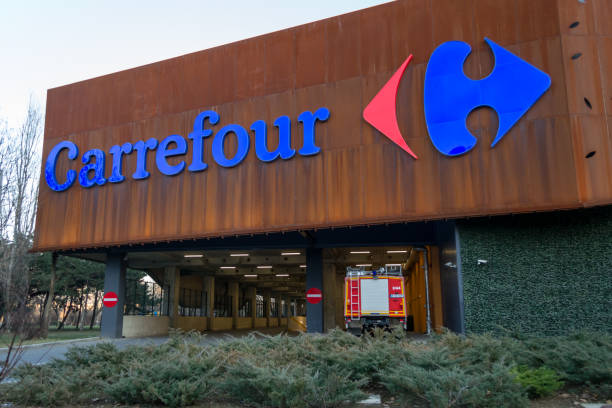 Carrefour supermarket logo on ParkLake Shopping Center mall. Carrefour is one of the largest hypermarket chains in the world. Fire truck and parking exit below. stock photo