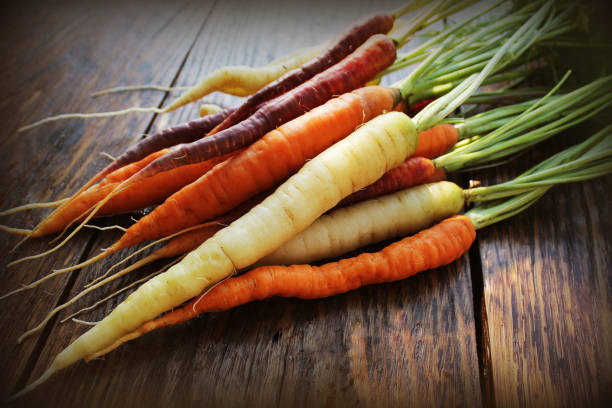 Carrots. Fresh colorful carrots on dark rustic background stock photo