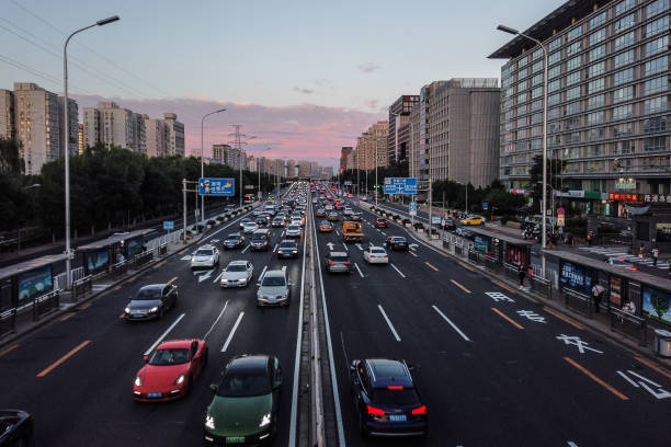 Cars driving in rush hour after work on the the East 2nd Ring Road at sunset, Beijing, China. stock photo