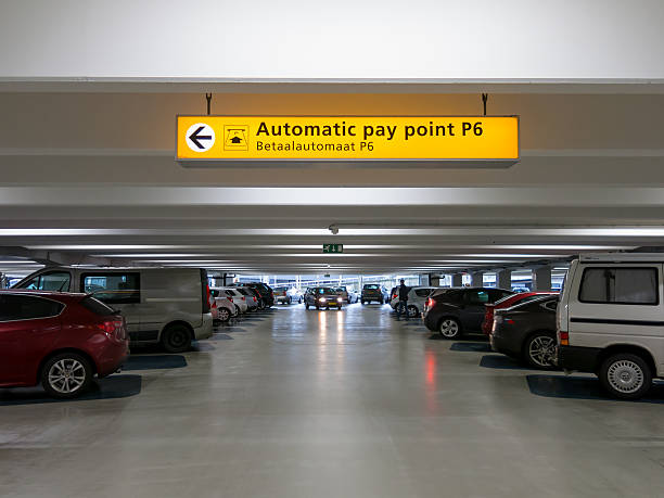 cars parked in parking garage at international airport - schiphol stockfoto's en -beelden