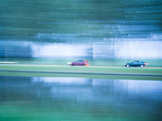 Cars passing by in an unsharp image stock photo