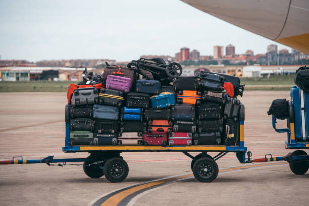 Cart with luggage at an airport A cart full of luggage in an airport luggage cart stock pictures, royalty-free photos & images