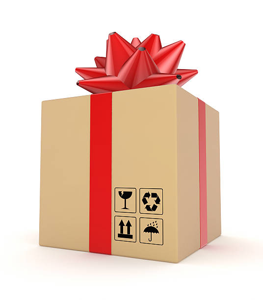 Carton box decorated with a red ribbon. stock photo