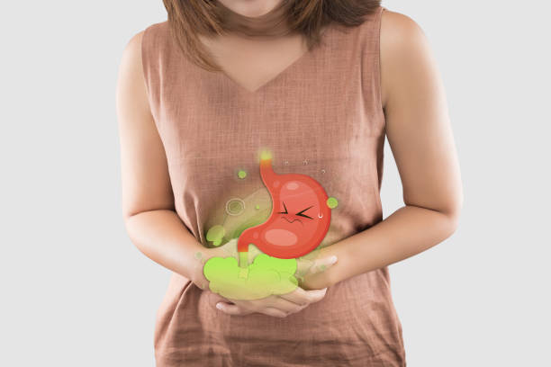 Cartoon stomach in the woman belly filled with gas the cause of flatulence and stomach ache, inflammatory bowel disease, Irritable Bowel Syndrome stock photo