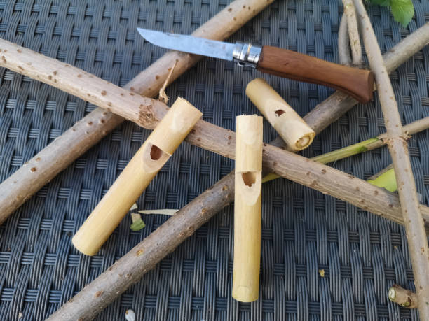 carved wooden whistles with a knive on a table carved wooden whistles with a knive on a table in the nature bushcraft stock pictures, royalty-free photos & images