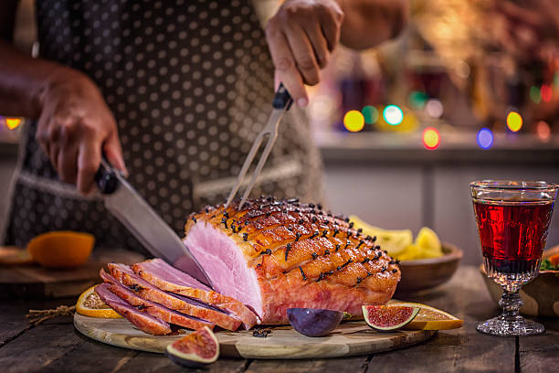 Carving Glazed Holiday Ham with Cloves Carving Delicous Glazed Holiday Ham with Cloves ham stock pictures, royalty-free photos & images