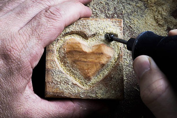 carving wood heart stock photo