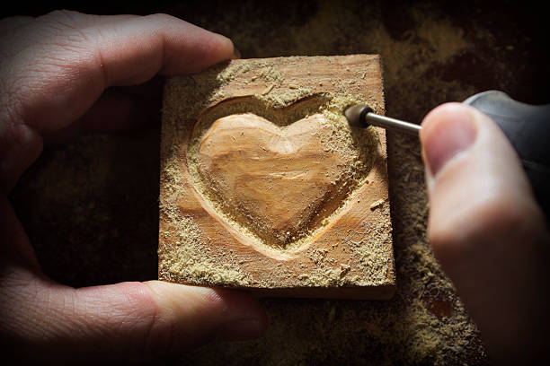 Carving wood in heart shape stock photo