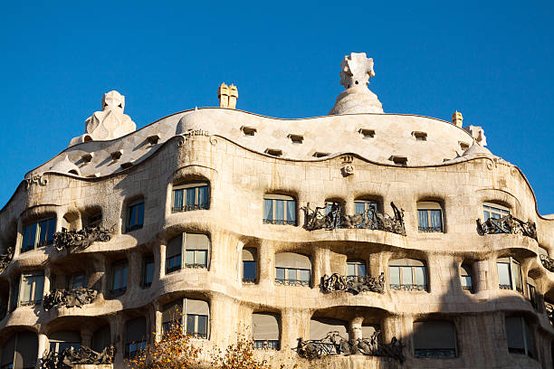 Casa Milà Barcelona, Spain - January, 7th 2012: Famous building Casa MilA  made by Gaudi in morning winter sunshine. On top are huge chimneys in shape of heads. casa mil�� stock pictures, royalty-free photos & images