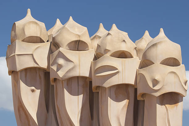 Casa Mila in Barcelona Barcelona, Spain, - April 24, 2013: Casa Mila. On the rooftop there are twenty-eight chimneys in several groupings  twisted so that the smoke came out better This chimneys become one of symbols of Barcelona.  casa milà stock pictures, royalty-free photos & images