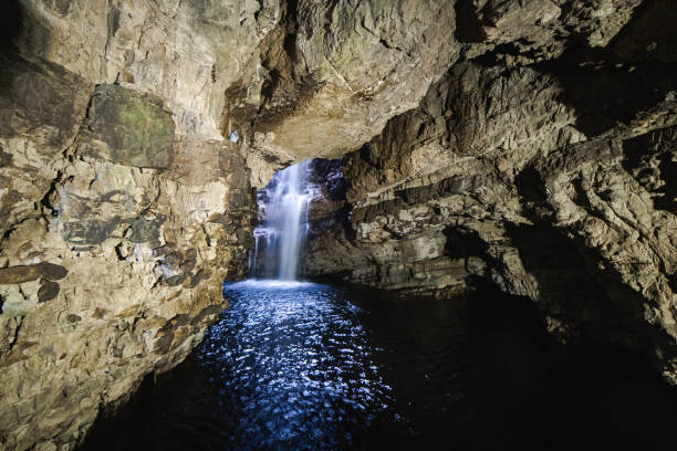 Cascading waterfall in underground cave Cascading waterfall in underground cave in Durness, Scotland, United Kingdom caithness stock pictures, royalty-free photos & images