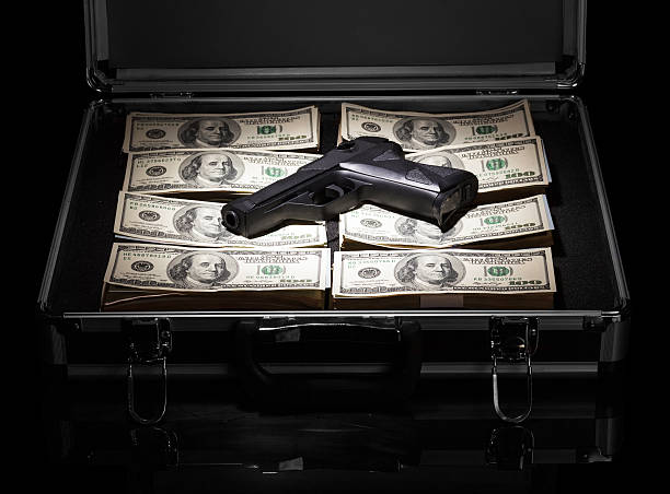Case with money and gun stock photo