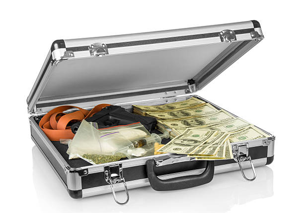 Case with money, gun and drugs stock photo