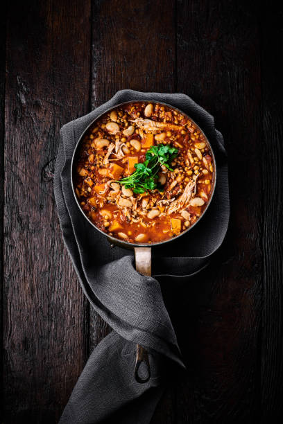 Casserole with chicken in a pan Top view of casserole with chicken in a pan on wooden background casserole dish stock pictures, royalty-free photos & images