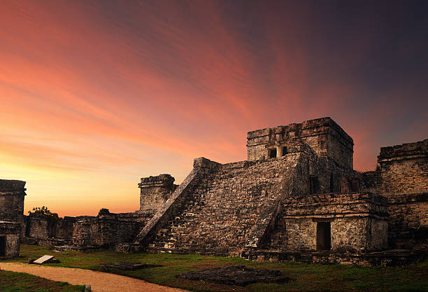 Castillo fortress in ancient Mayan city of Tulum Castillo fortress at sunset in the ancient Mayan city of Tulum, Mexico mayan stock pictures, royalty-free photos & images