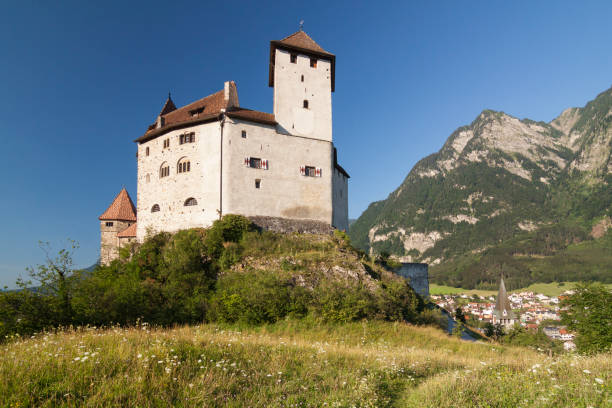 Castle Gutenberg on hilltop between greenery and Alps. Balzers, Liechtenstein stock photo