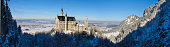 Hohenschwangau, Germany - January 26, 2013: Panorama view at winter to castle Neuschwanstein, built at year 1869 from bavarian king Ludwig II. This world famous castle is the most visited landmark in Germany, located nearby city Fuessen in Bavaria.