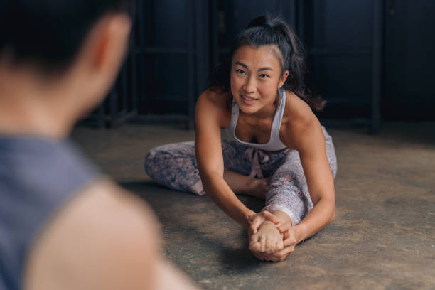 Casual conversations during warm up before the yoga session stock photo