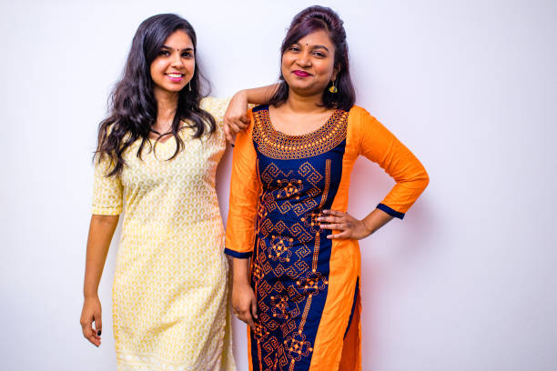 casual indian clothes ,two Indian woman in kurta posing over white wall stock photo