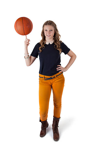 Casual Teenage Girl With Basketball Balancing On Her Finger stock photo