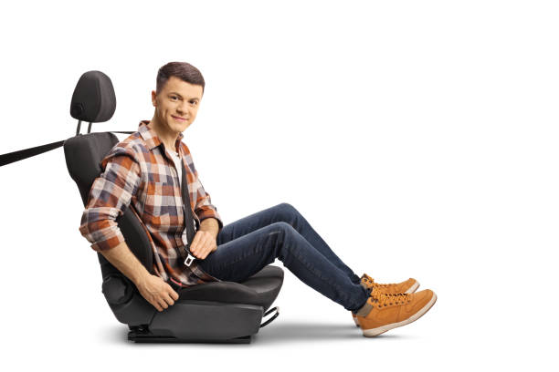 Casual young man buckling up a seat belt and looking at camera stock photo