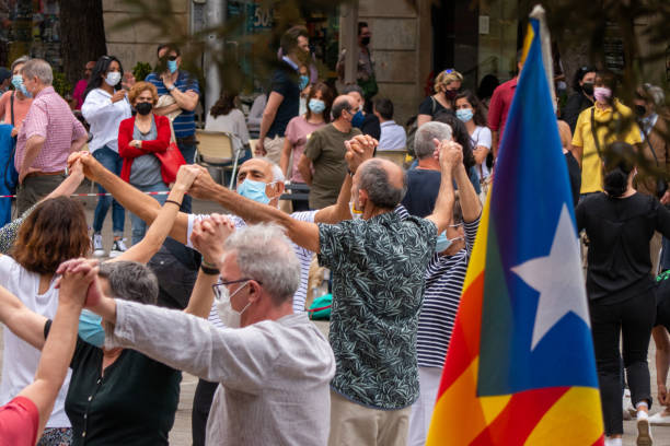 Catalan people dancing Sardana in circle, typical traditional show and Catalunya flag stock photo
