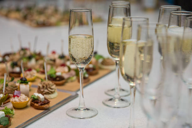 Catering Banquet table with canapes, snacks, festive table, slices, glasses Catering Banquet table with canapes, snacks, festive table, slices, glasses reception canape photos stock pictures, royalty-free photos & images
