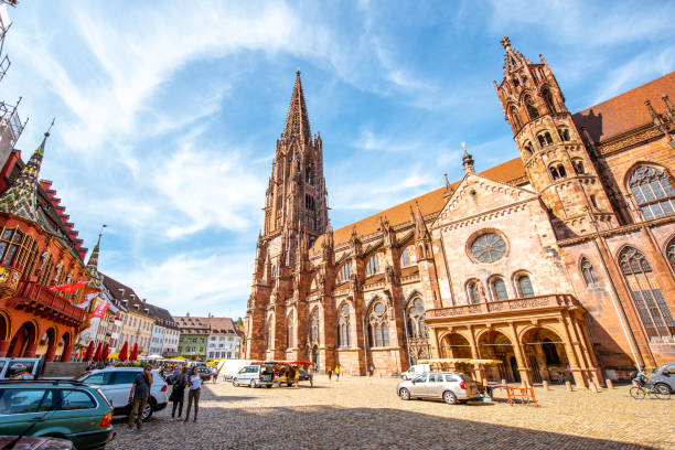 Cathedral in Freiburg, Germany FREIBURG, GERMANY - September 10, 2017: Cityscape view on the main cathedral in the old town of Freiburg, Germany muenster cheese stock pictures, royalty-free photos & images
