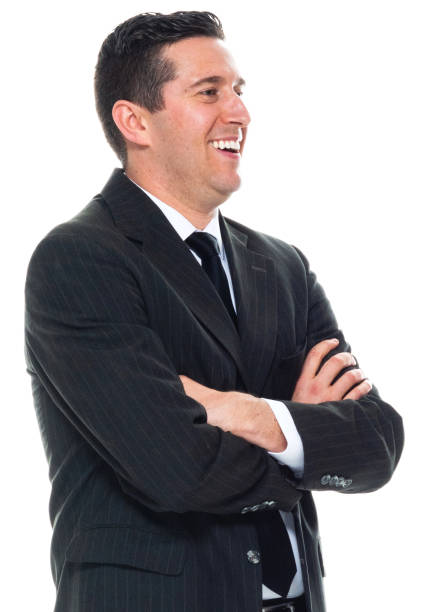 Caucasian male business person standing in front of white background wearing businesswear stock photo