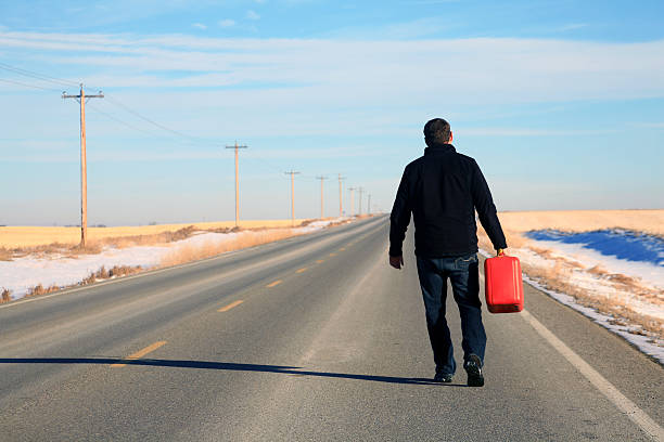 Caucasian Male Running Out of Gas on Highway stock photo