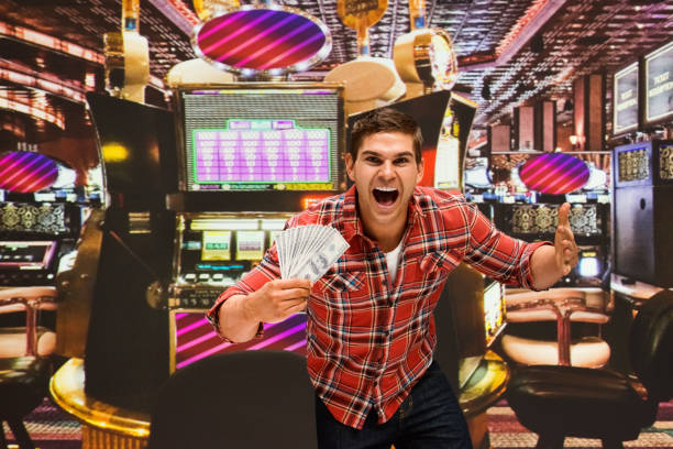 117 Handsome Man Playing The Slot Machine Stock Photos, Pictures &amp;  Royalty-Free Images - iStock