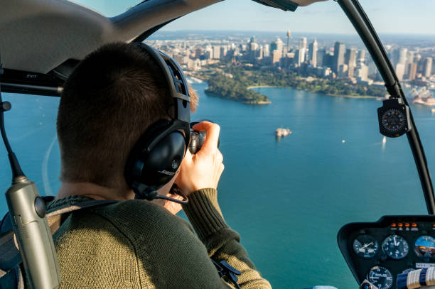 Caucasian man taking photos of Sydney CBD and Sydney harbour from helicopter stock photo