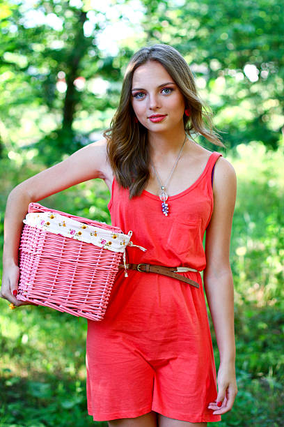 Caucasian young woman with pink vintage basket stock photo