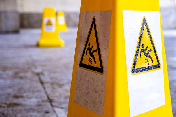 caution slippery surface sign caution wet floor sign at a sidewalk slip and fall stock pictures, royalty-free photos & images