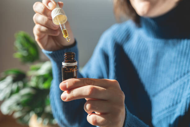 Cbd alternative therapy - Woman holding bottle of cannabis oil for anxiety treatment stock photo