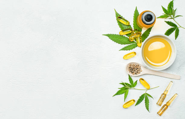 cbd oil, capsules, hemp leaves and seeds cbd oil, capsules, leaves and seeds  cannabis on gray concrete table, concept of alternative medicine and cannabidiol products medical cannabis photos stock pictures, royalty-free photos & images