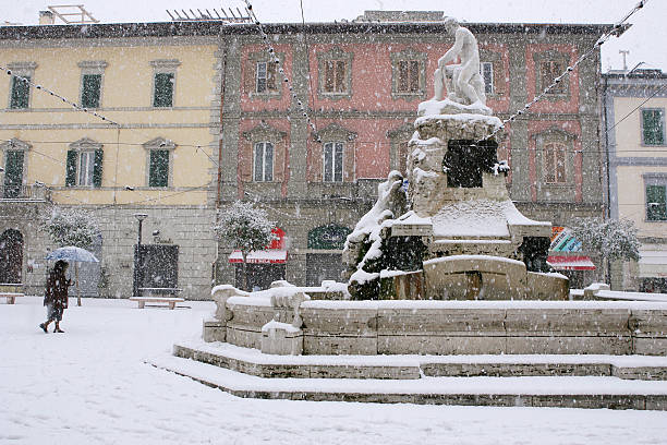 Cecina, Livorno, Tuscany - snowfall Cecina, Livorno, Tuscany - snowfall in the city, Piazza Guerrazzi with the Town Hall and the fountain of Maremma Thirsty white leghorn stock pictures, royalty-free photos & images