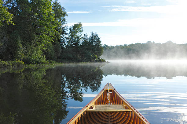 Cedar Canoe Bow on a Misty Lake stock photo