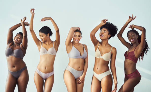 Celebrate your beautiful self Studio shot of a group of beautiful young women posing together in their underwear bra stock pictures, royalty-free photos & images