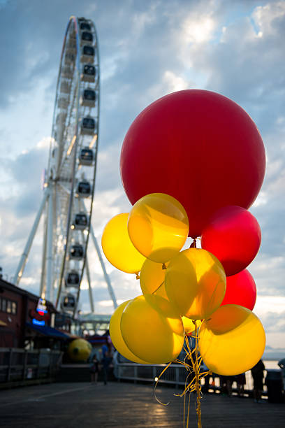 Celebration Concept Illuminated red and yellow balloons. zero gravity carnival ride stock pictures, royalty-free photos & images